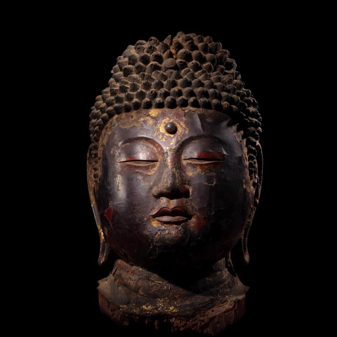 Gold and black lacquered head of Buddha, 8th to 12th century